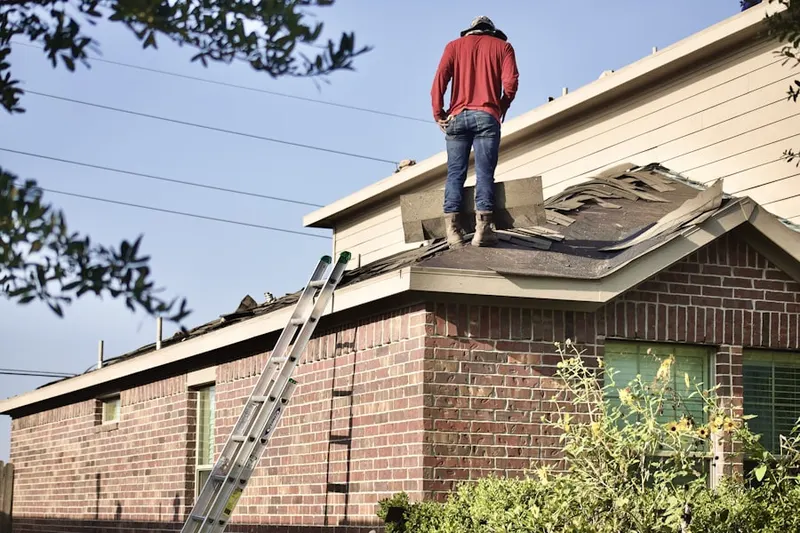 Professional roofer working on a residential roof in Little Rocky Hill